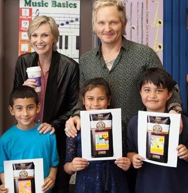 Jane Lynch and Matt Sorum with kids who designed artwork for limited edition Adopt the Arts coffee