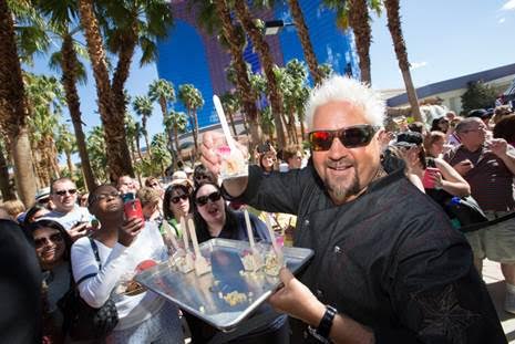 Guy Fieri hands out Corn off the Cob to a crowd outside El Burro Borracho. Credit - Erik Kabik