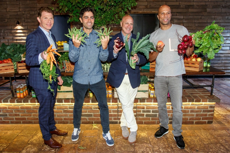 Bobby Flay, Adrian Grenier, Tom Colicchio and Common snap a fruit and vegetable selfie at Naked Juice's #DrinkGoodDoGood campaign launch event in Manhattan. For every selfie shared using the campaign hashtag, Naked Juice will donate 10 pounds of produce to communities in need. (PRNewsFoto/Naked Juice)